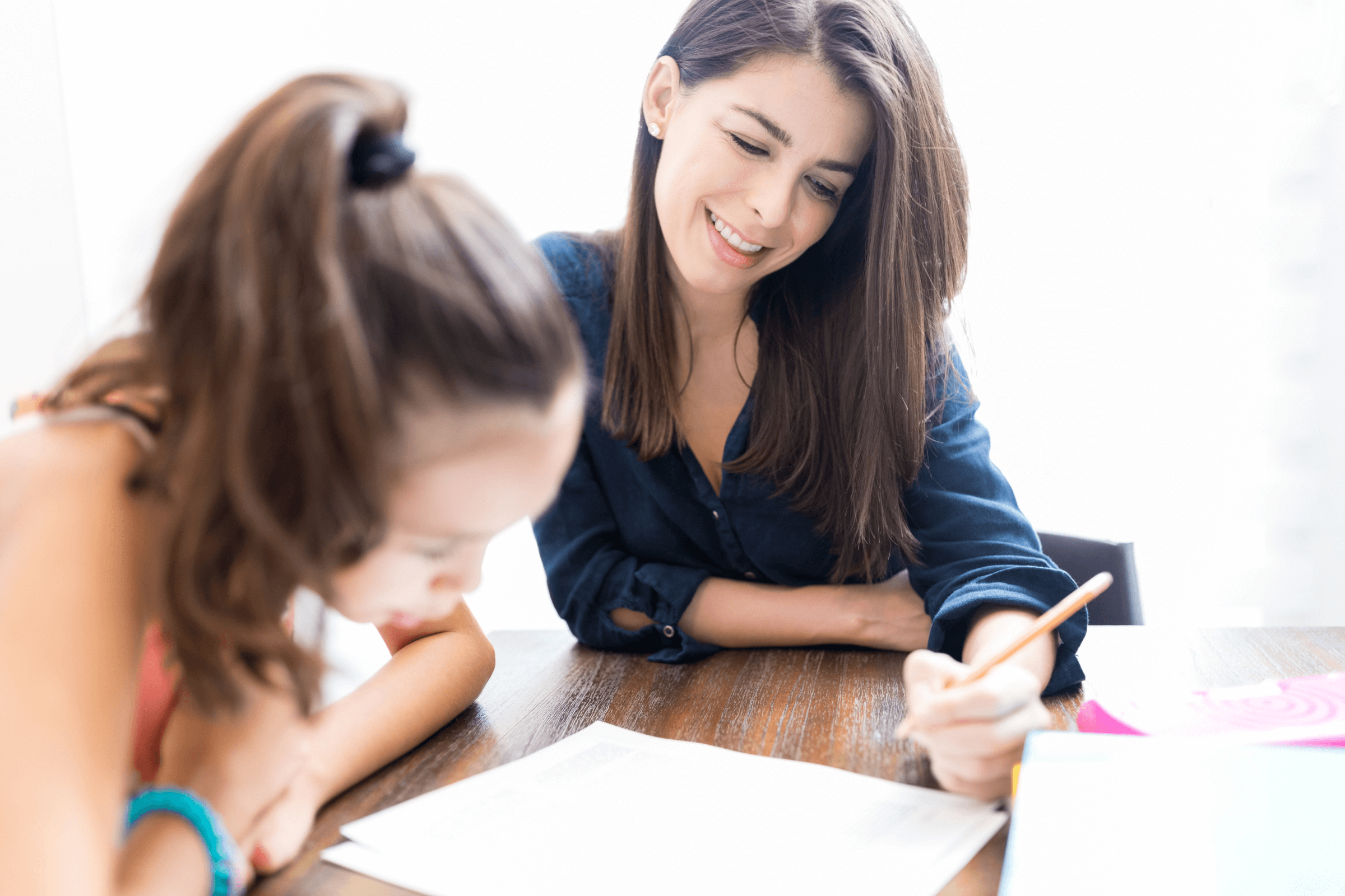 Teacher tutoring a young female student